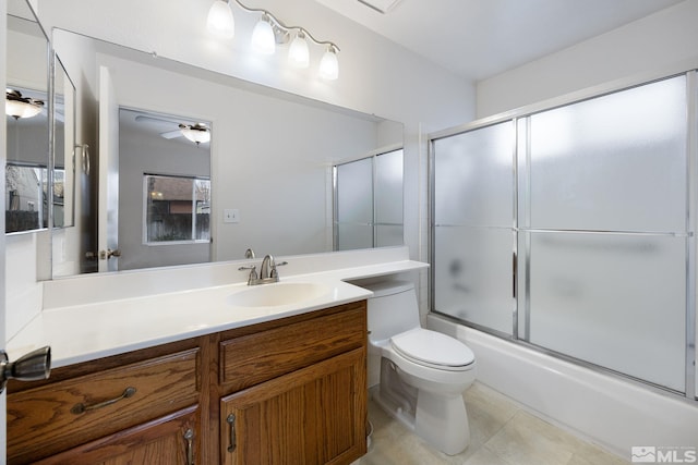 full bathroom with toilet, shower / bath combination with glass door, vanity, ceiling fan, and tile patterned flooring