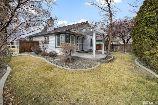 rear view of property with a patio, a yard, and a pergola