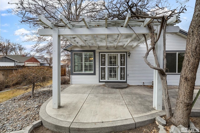 property entrance featuring a pergola and a patio area