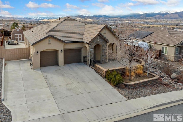 ranch-style house featuring a garage and a mountain view