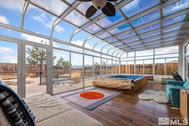 sunroom / solarium featuring ceiling fan