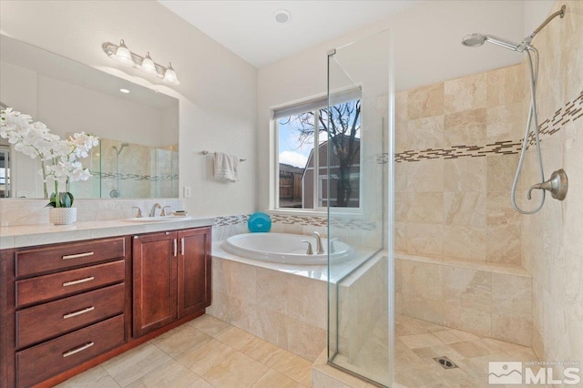 bathroom featuring independent shower and bath, vanity, and tile patterned flooring