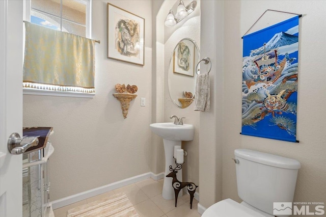 bathroom with tile patterned floors and toilet