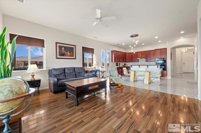 living room featuring hardwood / wood-style floors and ceiling fan