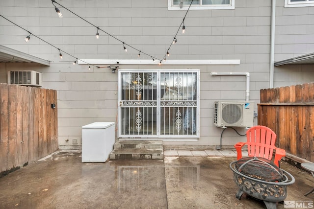 view of patio with ac unit and an outdoor fire pit