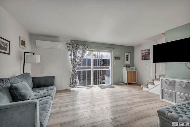 living room featuring light hardwood / wood-style floors and an AC wall unit