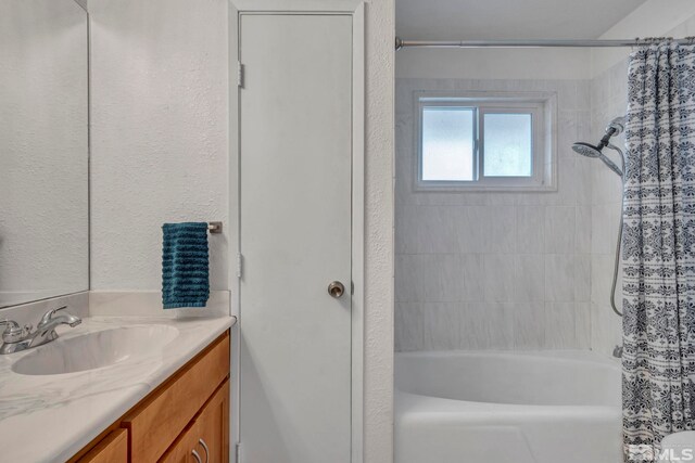 bathroom with vanity and shower / bathtub combination with curtain