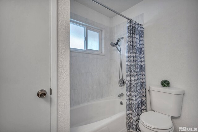 bathroom with toilet and shower / tub combo