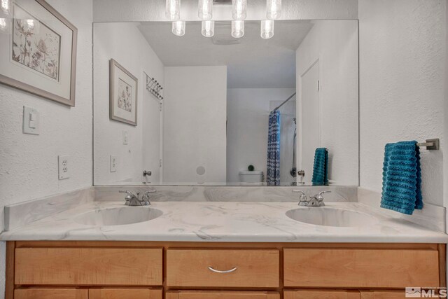 bathroom featuring walk in shower, vanity, and toilet