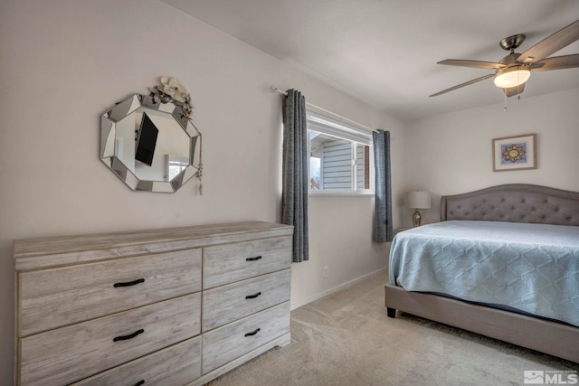 bedroom featuring ceiling fan and light carpet