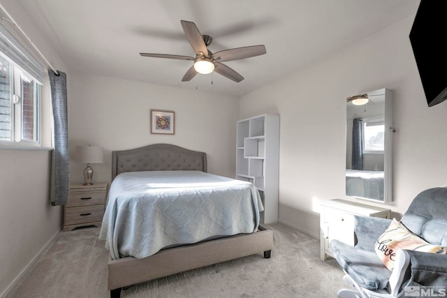 bedroom featuring light colored carpet and ceiling fan