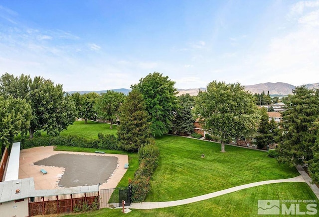 view of community with a mountain view and a yard