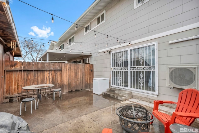 view of patio with ac unit and a fire pit