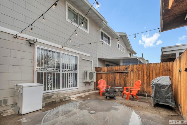 view of patio featuring ac unit, grilling area, and an outdoor fire pit