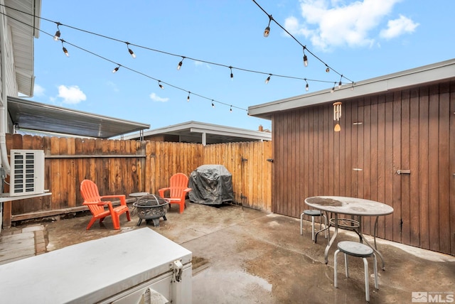 view of patio featuring area for grilling and a fire pit