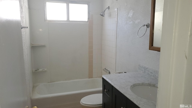 full bathroom featuring vanity, tiled shower / bath, and toilet