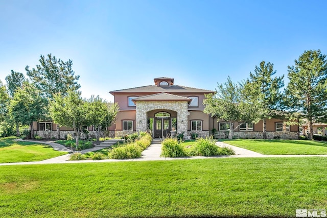 view of front of property featuring french doors and a front yard