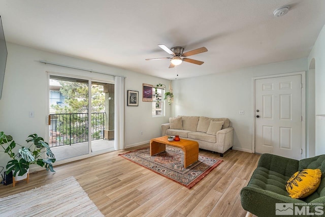 living room featuring ceiling fan and light hardwood / wood-style floors