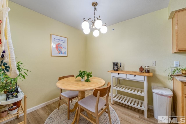 dining room featuring light hardwood / wood-style floors and a notable chandelier