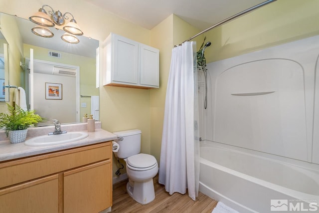 full bathroom with shower / tub combo with curtain, wood-type flooring, toilet, and vanity