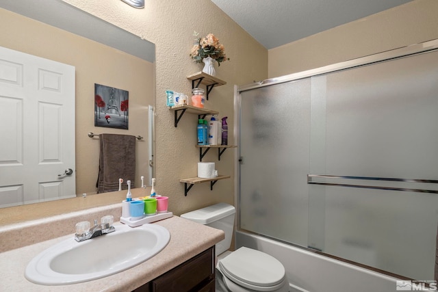 full bathroom featuring enclosed tub / shower combo, vanity, and toilet