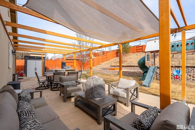 view of patio featuring a playground, outdoor lounge area, a pergola, and a shed