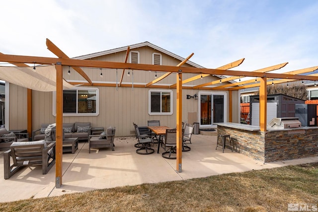 back of house with a bar, a storage shed, an outdoor living space, and a patio