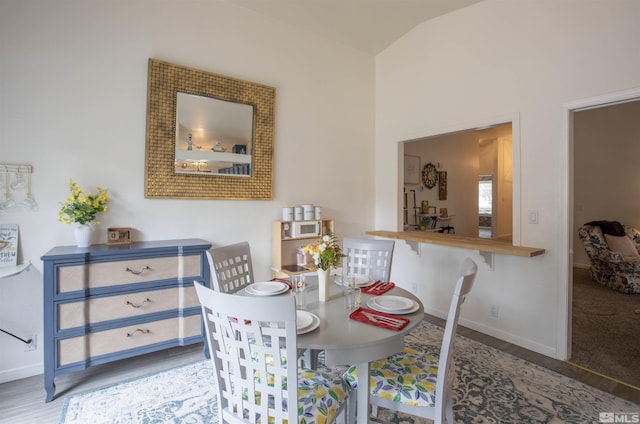 dining space with wood-type flooring