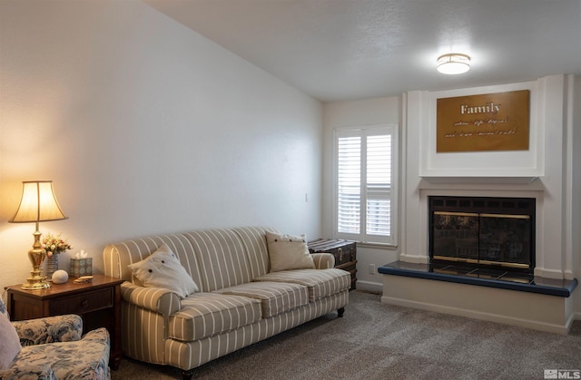 carpeted living room featuring vaulted ceiling and a fireplace