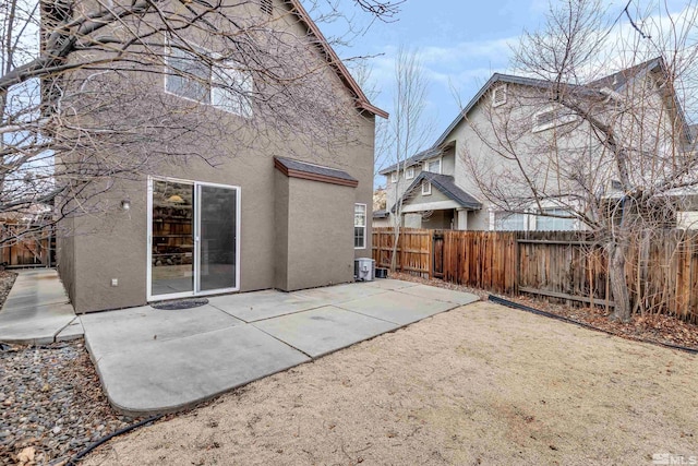 rear view of house with cooling unit and a patio