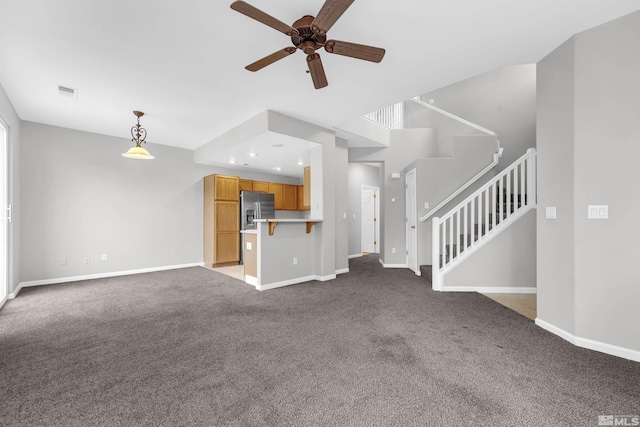 unfurnished living room with ceiling fan and light carpet