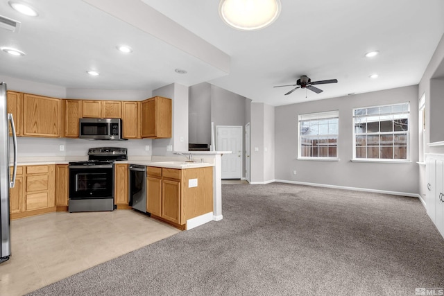 kitchen featuring sink, light colored carpet, kitchen peninsula, ceiling fan, and stainless steel appliances