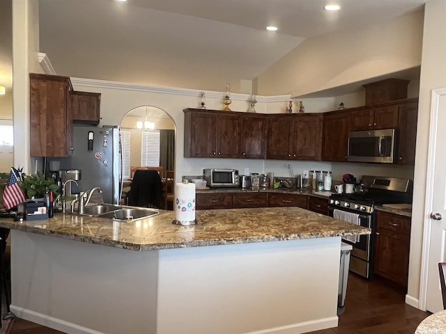 kitchen with lofted ceiling, sink, dark hardwood / wood-style flooring, dark brown cabinetry, and stainless steel appliances