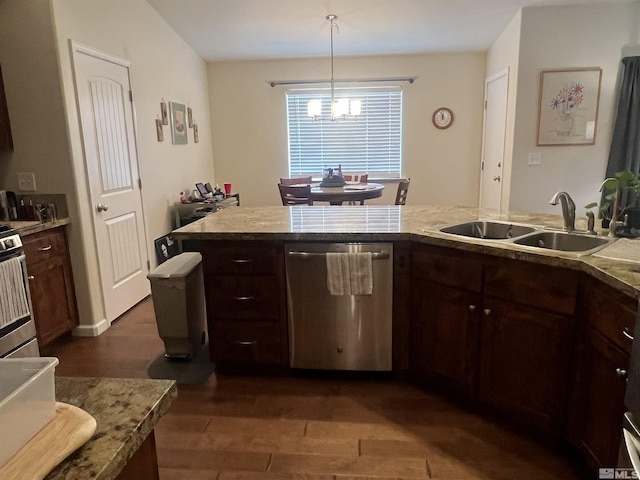 kitchen featuring dark brown cabinetry, appliances with stainless steel finishes, decorative light fixtures, and sink