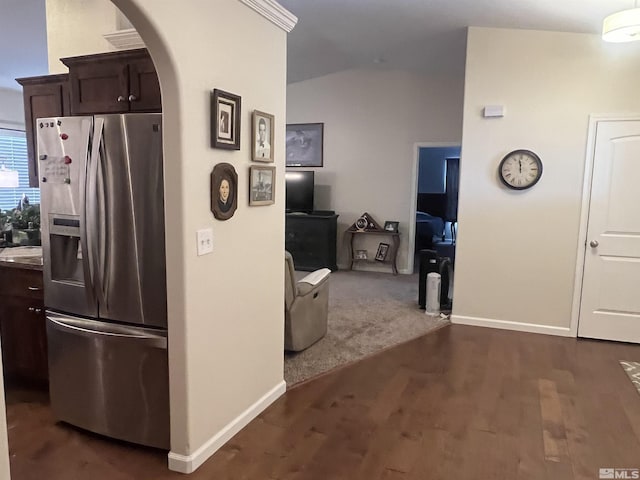 kitchen featuring dark hardwood / wood-style flooring, dark brown cabinets, and stainless steel fridge