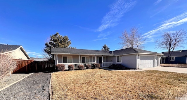 ranch-style house with a garage, covered porch, and a front yard