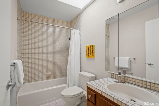 full bathroom featuring vanity, toilet, a skylight, and shower / bath combo with shower curtain