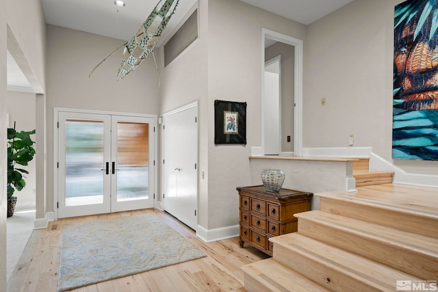 entryway featuring light hardwood / wood-style floors and french doors