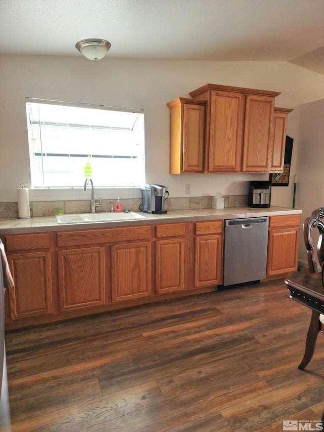 kitchen with vaulted ceiling, dark hardwood / wood-style flooring, dishwasher, and sink