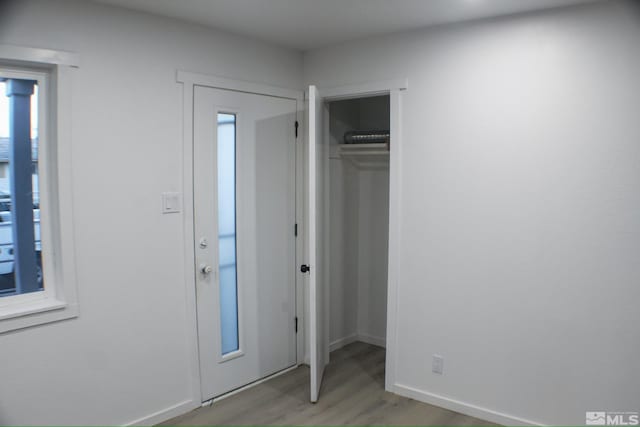 unfurnished bedroom featuring wood-type flooring and a closet