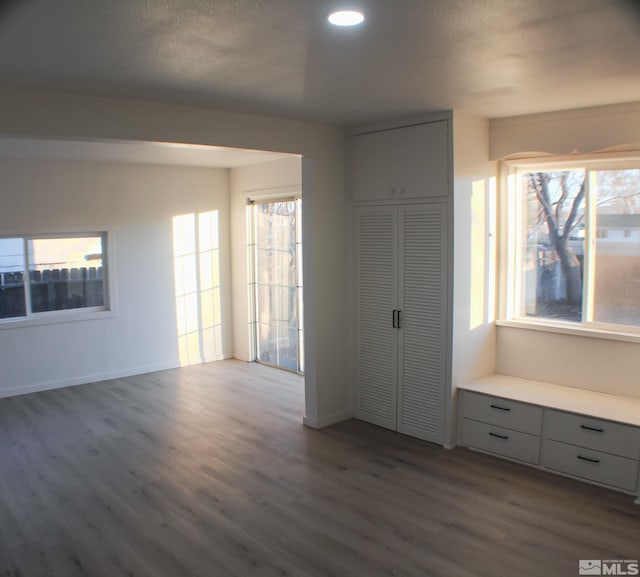 unfurnished bedroom featuring dark wood-type flooring and a closet