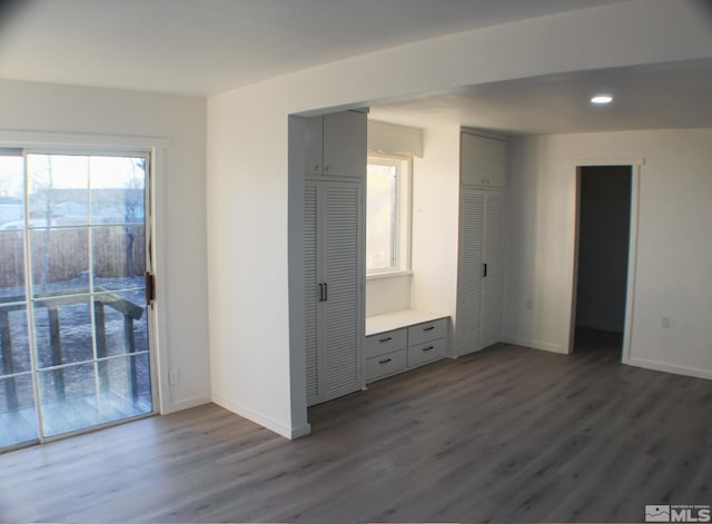 unfurnished bedroom with access to exterior and hardwood / wood-style floors