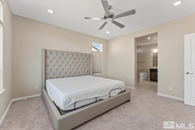 bedroom featuring connected bathroom, light colored carpet, and ceiling fan