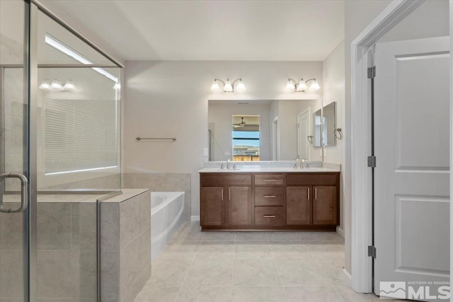 bathroom with tile patterned flooring, vanity, and separate shower and tub