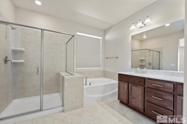 bathroom featuring tile patterned flooring, vanity, and shower with separate bathtub