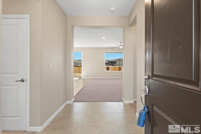 corridor with light tile patterned flooring