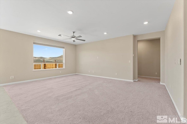 unfurnished room with ceiling fan and light colored carpet