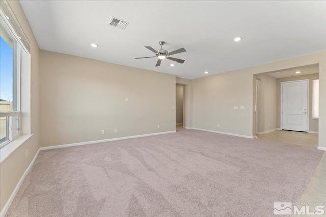 carpeted spare room with ceiling fan