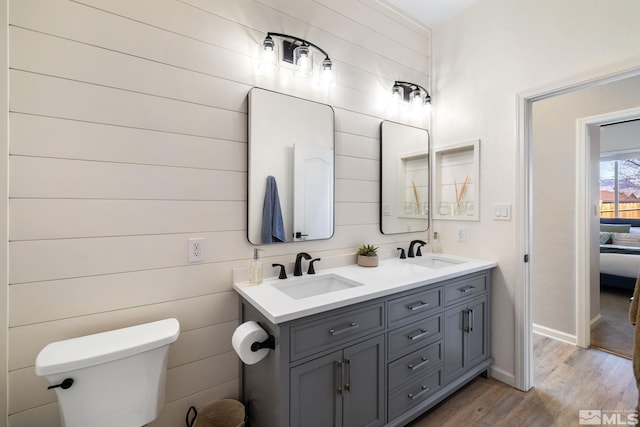 bathroom with vanity, hardwood / wood-style floors, and toilet