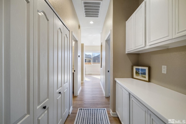 hallway with wood-type flooring